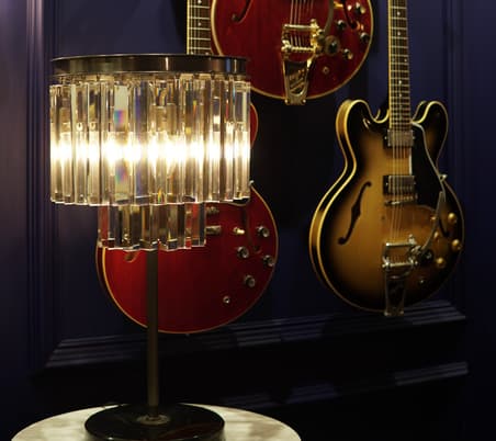 Timothy Oulton Odeon table lamp displayed with classic Gibson guitars