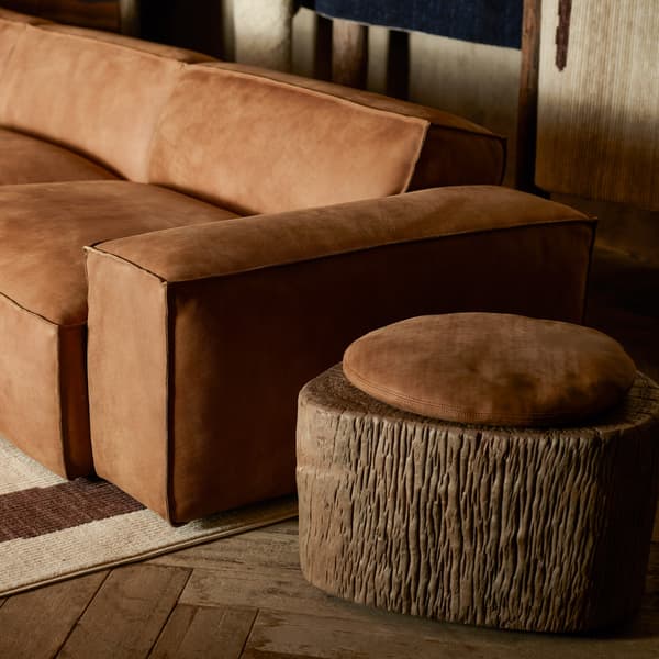 Veg wood block with seat pad next to sofa