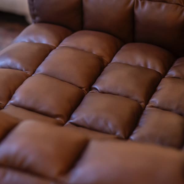 Puffy Chair in Brown Nappa leather cropped close up image