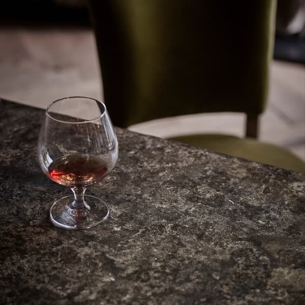 Monastery Dining Table close up image featuring glass