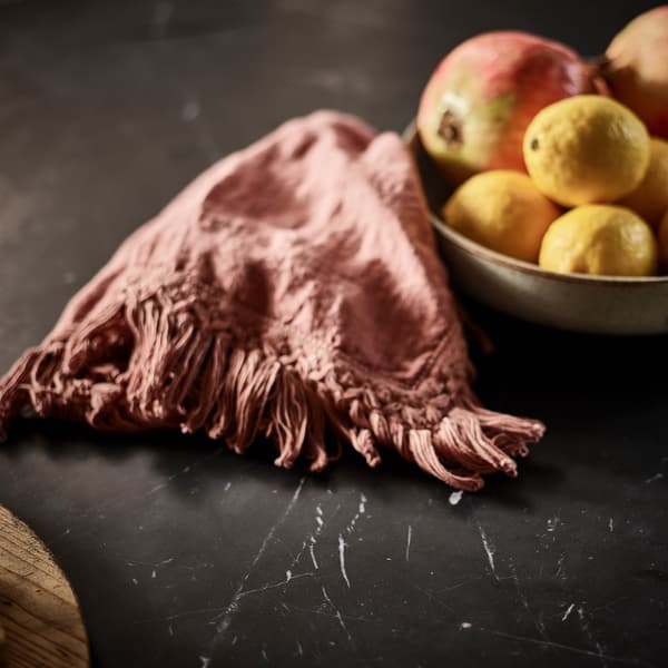 Invictus Dining Table featuring bowl of fruit on surface