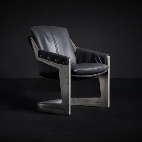 Grand Prix Armchair in Perforated Road Racer Carbon & Raw Steel side angle view