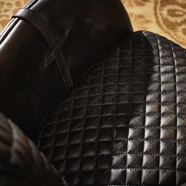 Saddle armchair close up image of seat