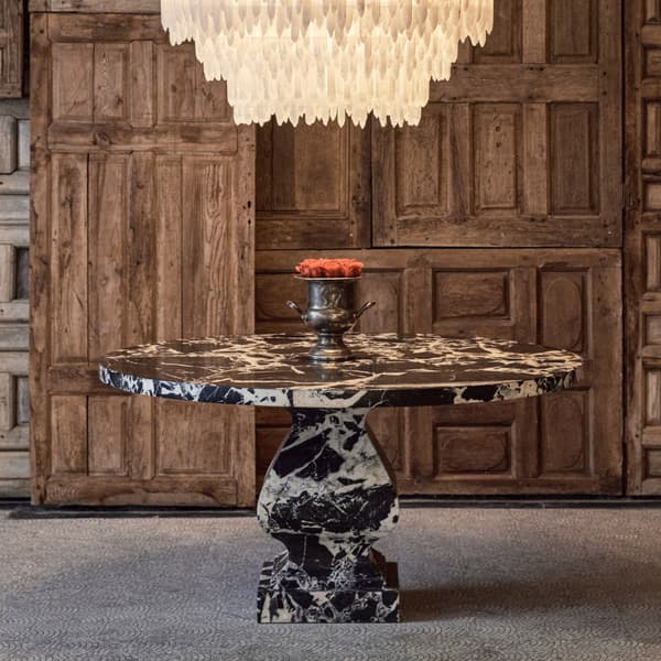 Pedestal round dining table featured with selenite chandelier