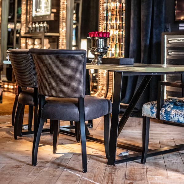 Mimi stud dining chair featured at table