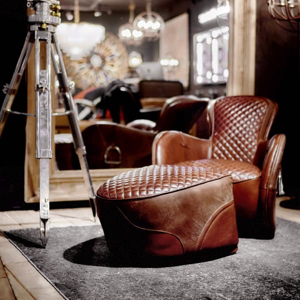 Saddle footstool displayed with Saddle Chair