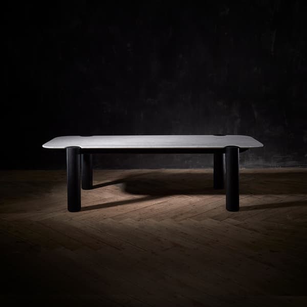 Isolated marble dining table on a dark wooden floor